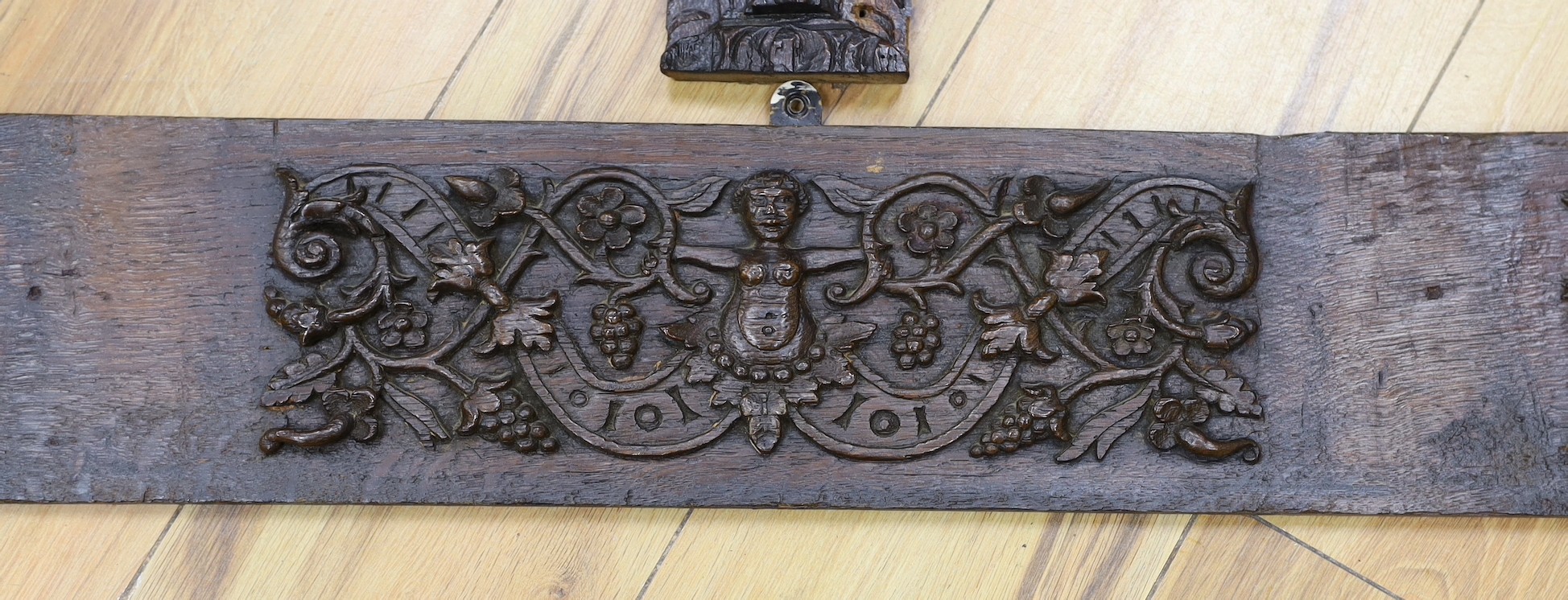 A 17th carved oak figural corbel, a pair of carved oak corbels and a carved oak frieze 14x19cm